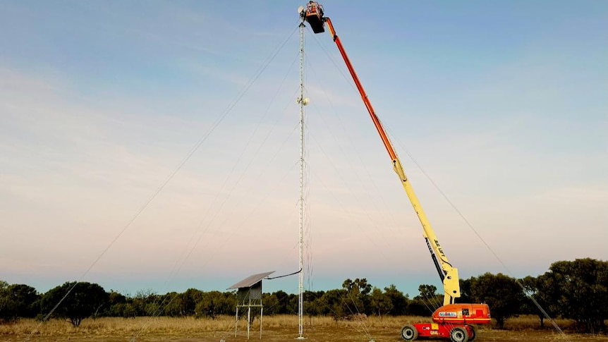 An internet tower is erected in an outback field