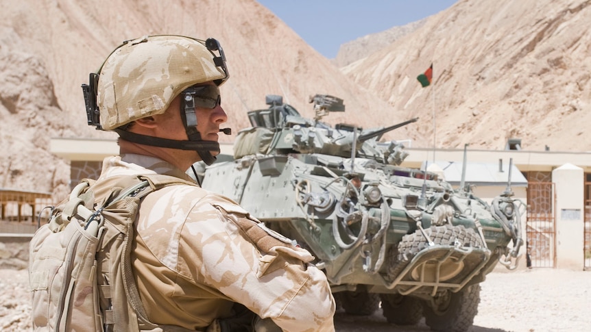 New Zealand soldier with armoured vehicle in Afghanistan