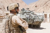 New Zealand soldier with armoured vehicle in Afghanistan
