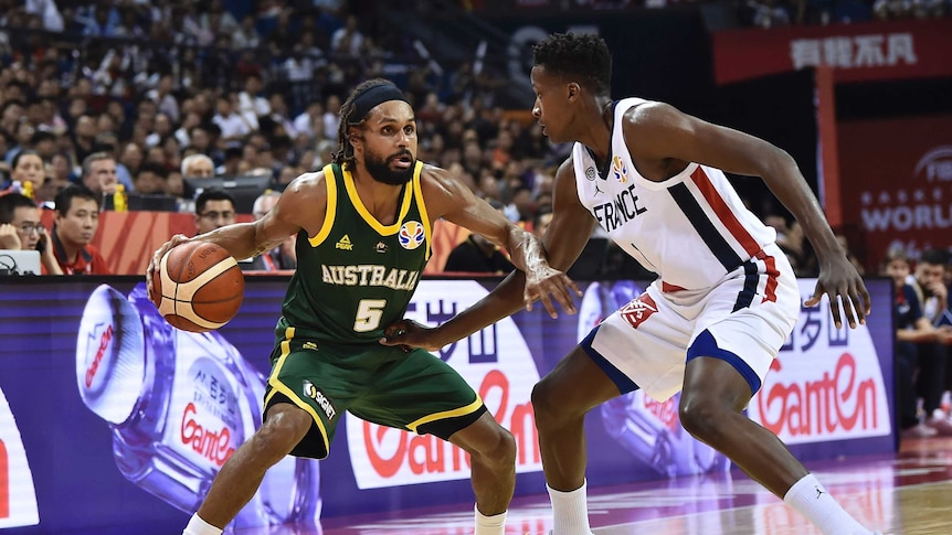 Australian Basketball player Patty Mills protects the ball in a World Cup match against France