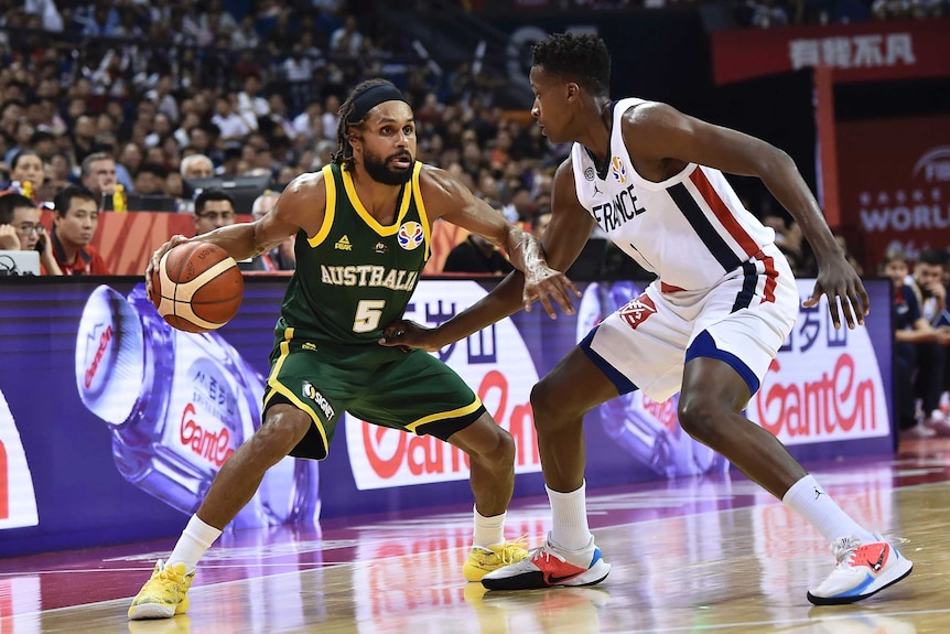 Australian Basketball player Patty Mills protects the ball in a World Cup match against France