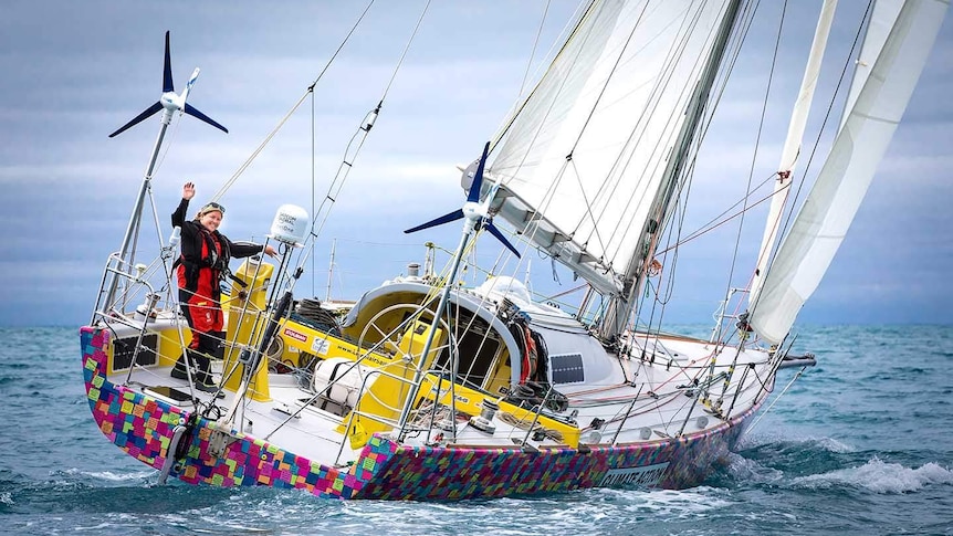 Solo sailor Lisa Blair waves from the back of her yacht Climate Action.