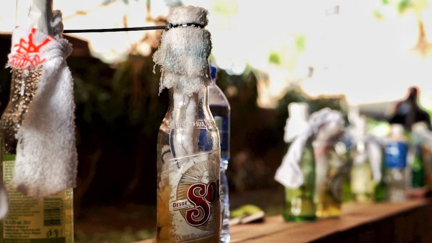 A Sol beer bottle has a rag cable-tied to the top of it, turning it into a Molotov cocktail for use in the Hong Kong protests.
