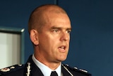 A head and shoulders shot of Simon Overland wearing a police uniform.