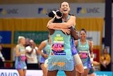 Sinclair jumps on Jok as they celebrate their first victory in Mavericks colours
