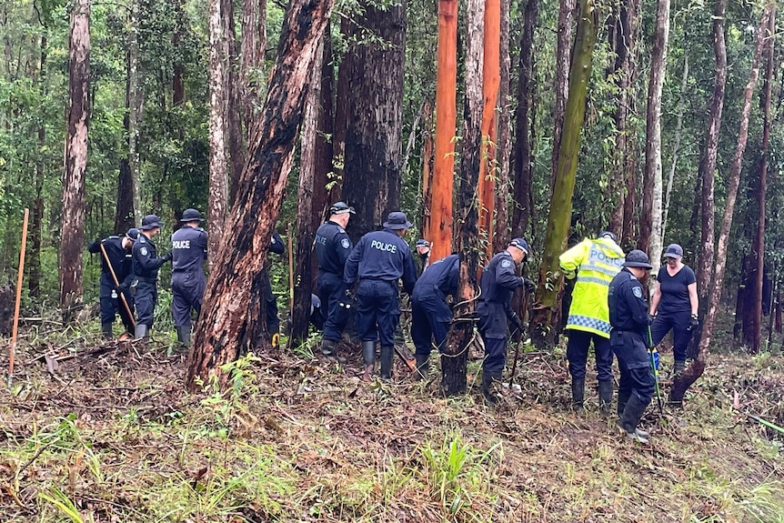 Police officers digging