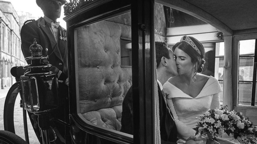 Princess Eugenie of York and Jack Brooksbank embrace, in the Scottish State Coach, upon its return to Windsor Castle.