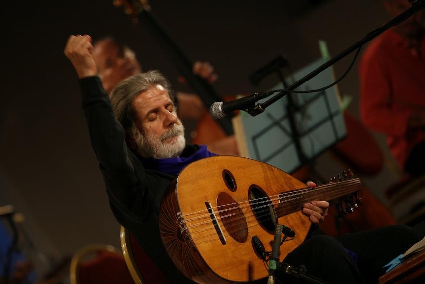 Marcel Khalife with oud onstage