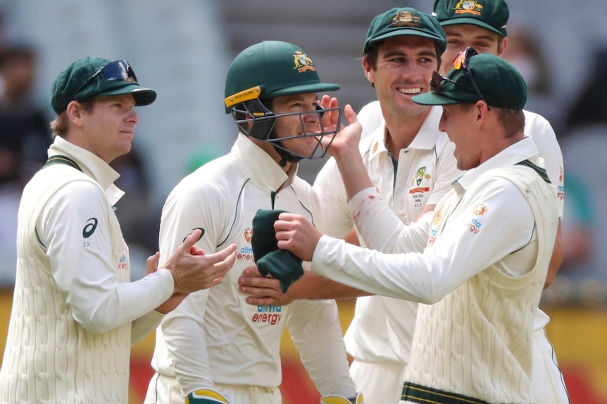 Tim Paine is joined in celebration by Steve Smith, Pat Cummins and Marnus Labuschagne