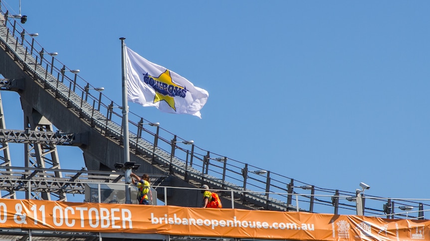 The North Queensland Cowboys flag has been raised on the Story Bridge in Brisbane after a wager between Queensland ma