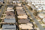 An aerial view of a new suburb with townhouses and apartments.