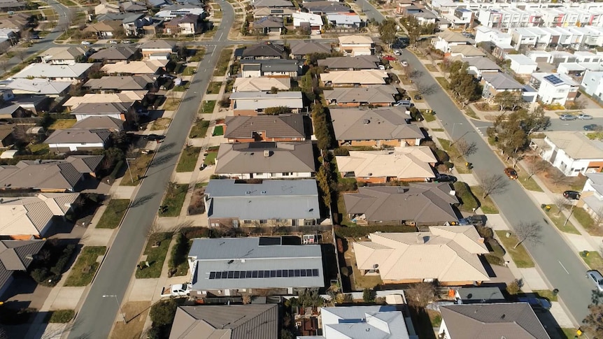 An aerial view of a new suburb with townhouses and apartments.