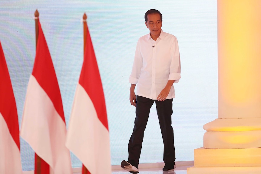 Indonesian presidential candidate Joko Widodo walks during a televised debate in Jakarta.