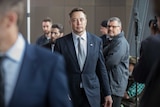 Elon Musk looks toward the camera.