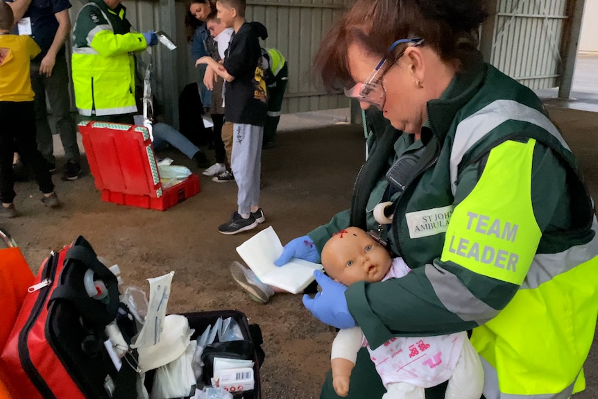 Ambulance officer treats doll as an injured baby