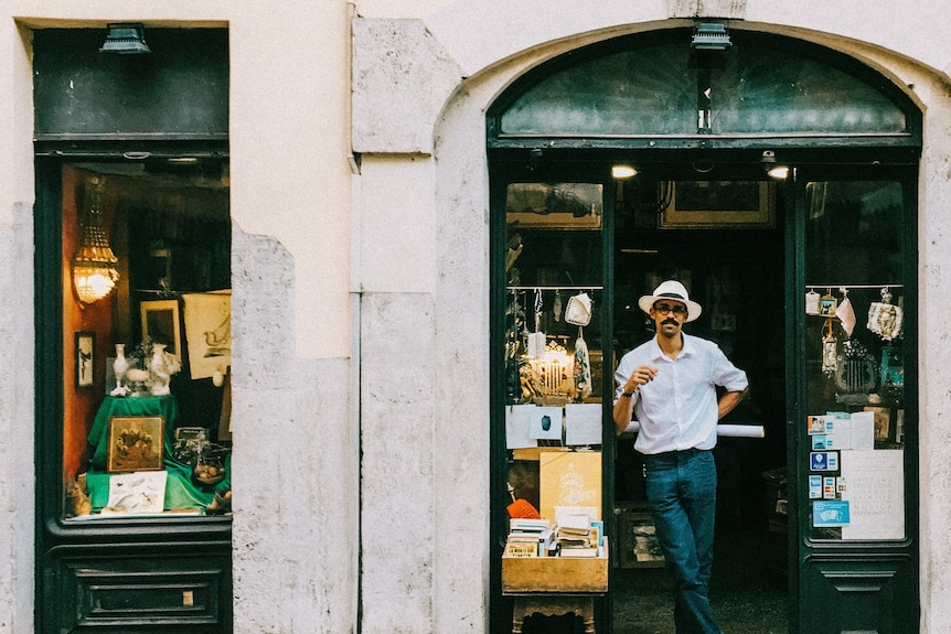 A man stands in the doorway of a bookshop in Rome
