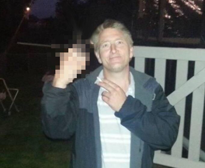 Man holding up middle finger.