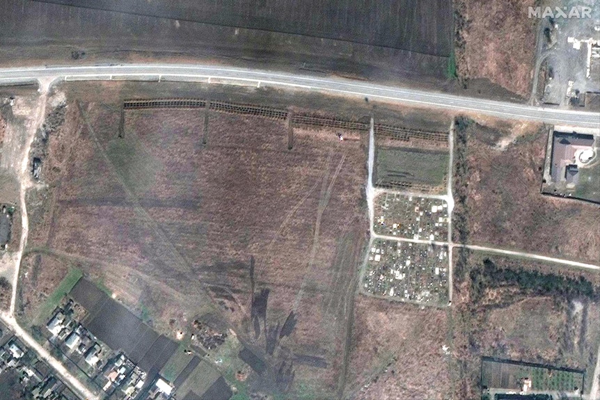 A satellite image shows an overview of new graves in the fields.