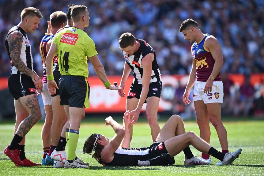 Nathan Murphy on the ground after a head knock in the 2023 AFL grand final.