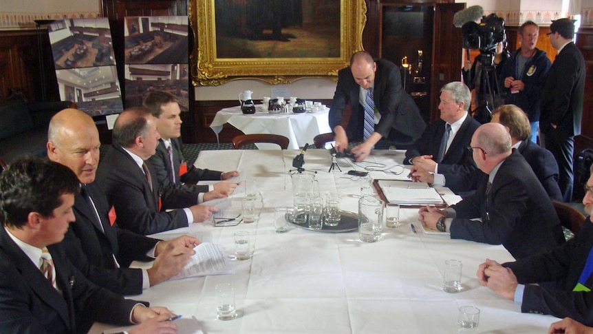 The delegates around a table to sign the agreement