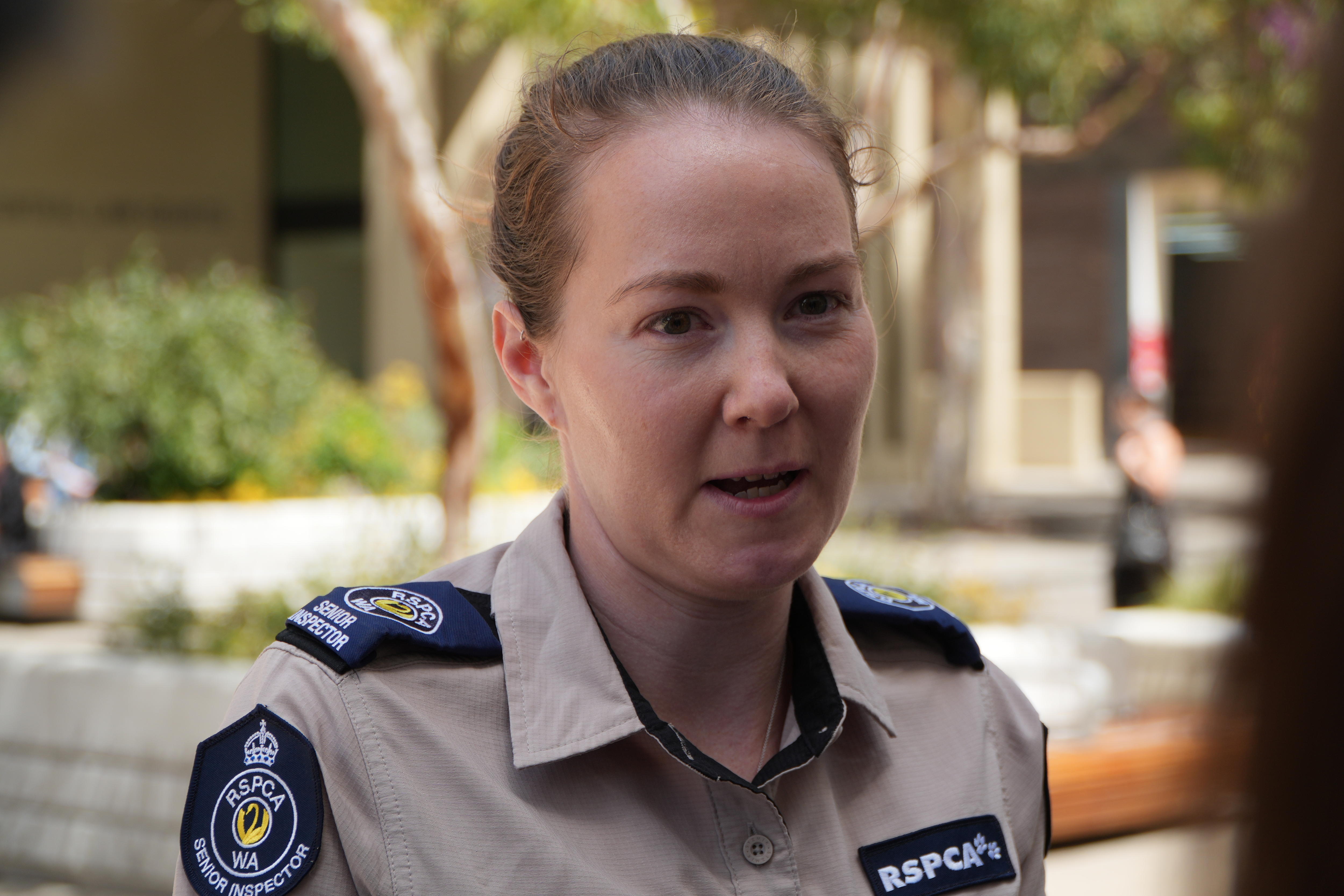 Jayde Palin speaks outside court wearing RSPCA uniform, with tied back brown hair.