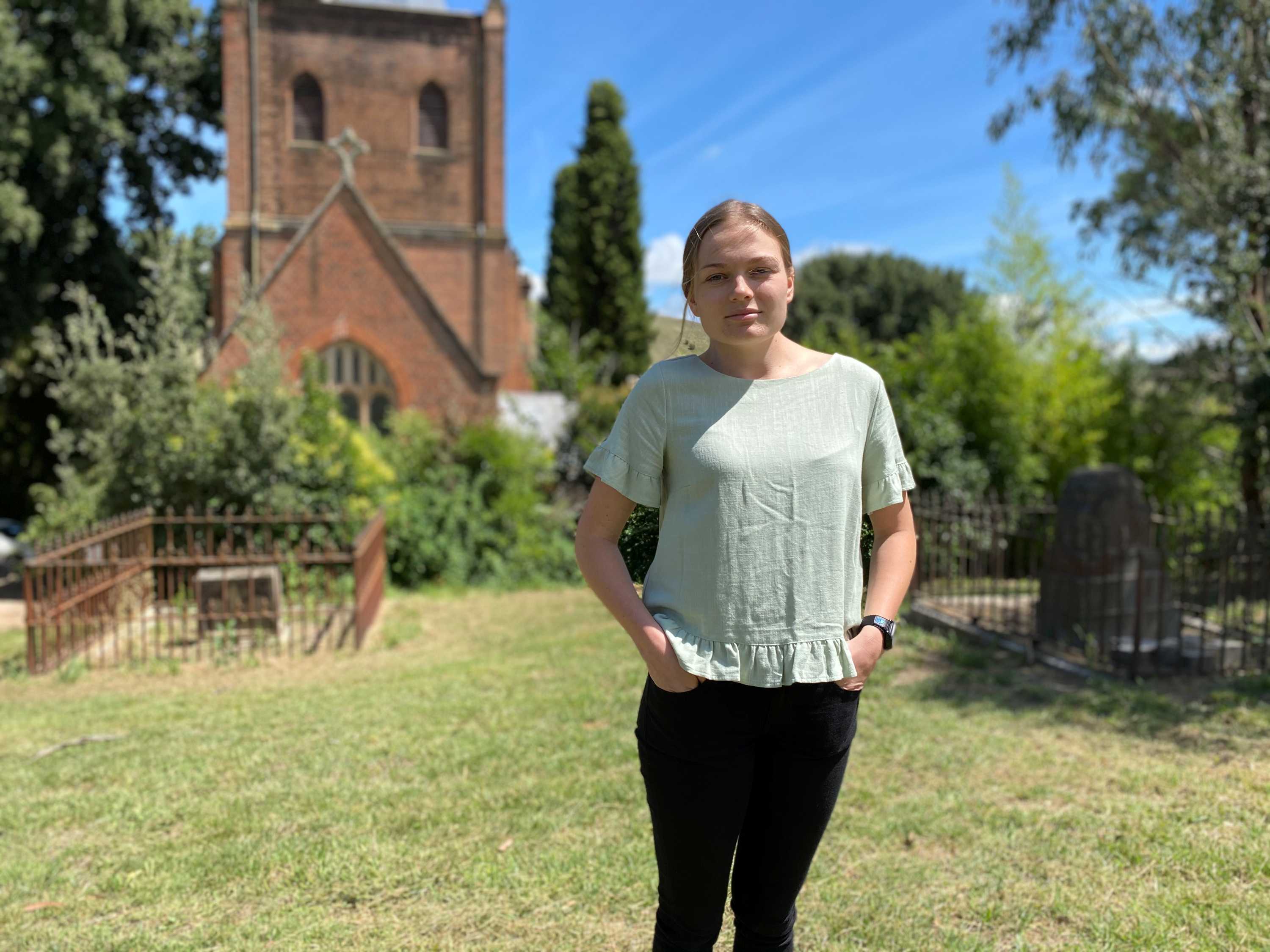 Save St. Pauls Church coordinatory McKenzie Graham stands in church garden