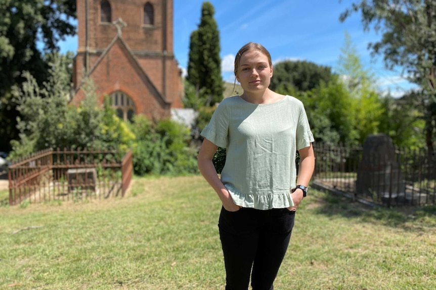 Save St. Pauls Church coordinatory McKenzie Graham stands in church garden