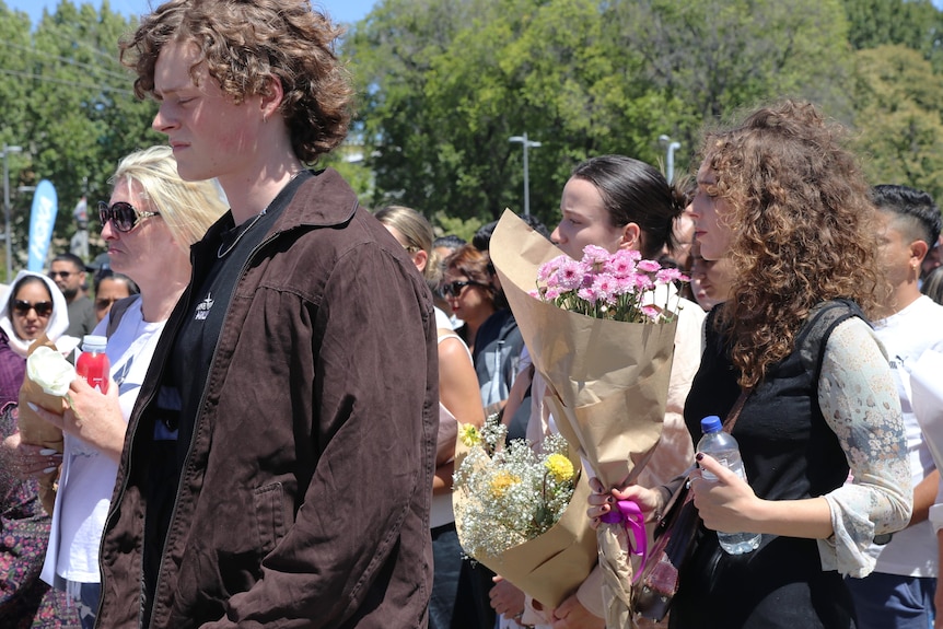 Young mourners in procession during a vigil.