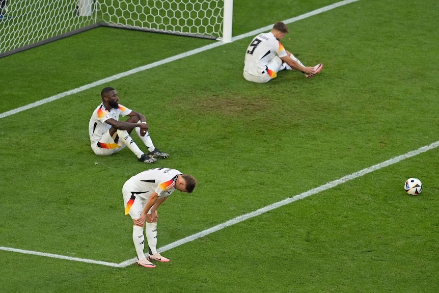 Germany players sit on the grass