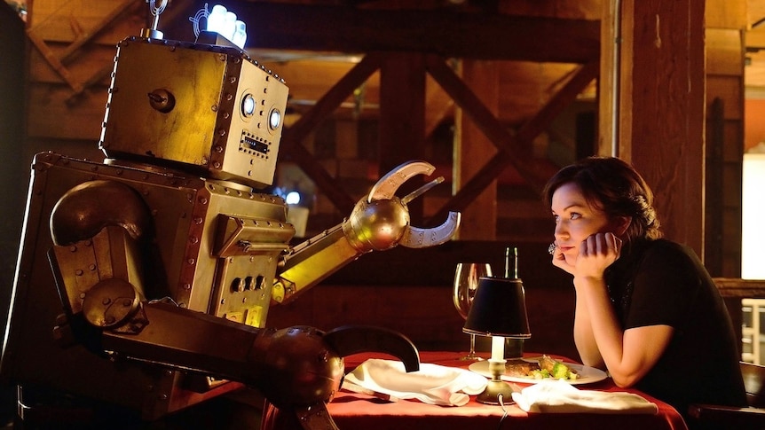 Bored looking woman at a table on a date with a robot