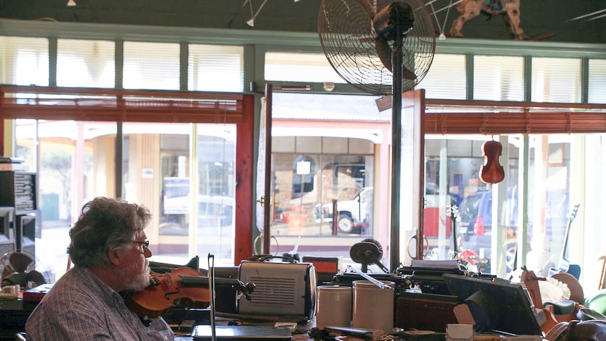 Farmer and musician Allan Walsh sits in store on Gulgong's main street