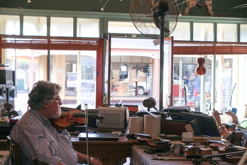 Farmer and musician Allan Walsh sits in store on Gulgong's main street