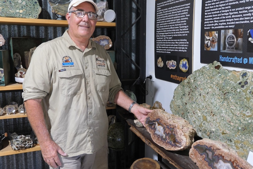 Don Kayes stands before a large polished thunder egg inside his shed.