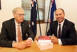 Commissioner Kenneth Hayne and Treasurer Josh Frydenberg (right) are seen with the final report from the Royal Commission.