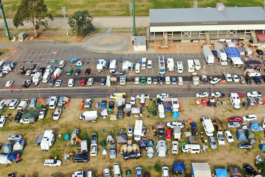 An aerial image of tents and caravans set up at a race track.