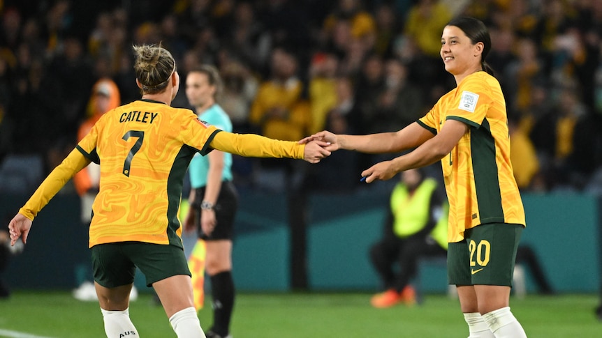 Steph Catley hands the Matildas' captain's armband to Sam Kerr during Australia's 2-0 win over Denmark in the Women's World Cup.