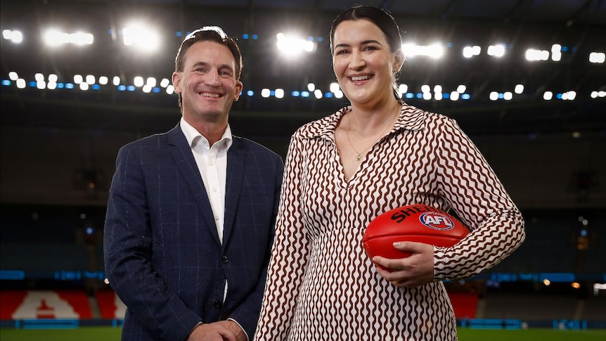 Laura Kane (right) pictured holding a football alongside Andrew Dillon.