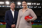 Laura Kane (right) pictured holding a football alongside Andrew Dillon.