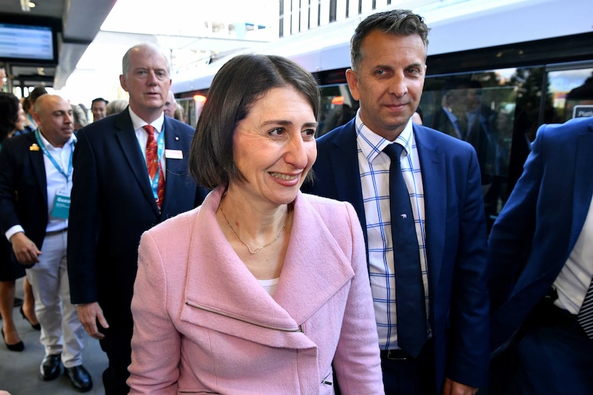 The premier smiling with a train in the background