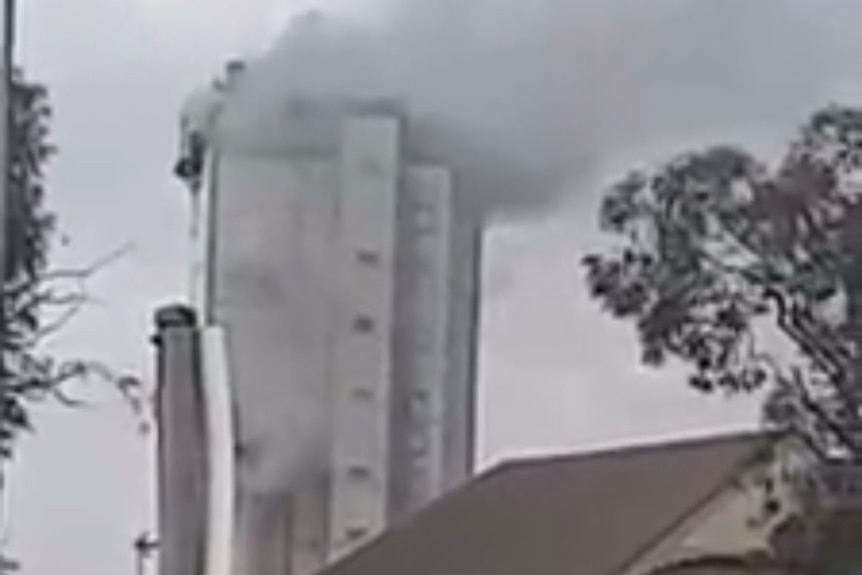 Smoke billows from what looks like a mid-sized office building, but is actually a smelter furnace.