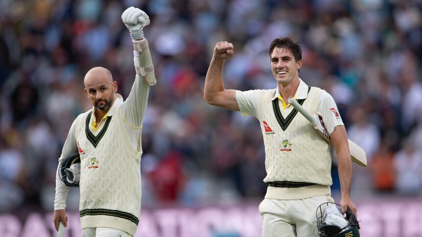 Australia batters Nathan Lyon and Pat Cummins walk off the field with fists raised after winning the Edgbaston Ashes Test.