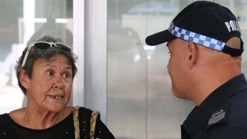 Former Retta Dixon Home resident Sue Roman speaks to NT Police Senior Sergeant Anthony Deutrom.
