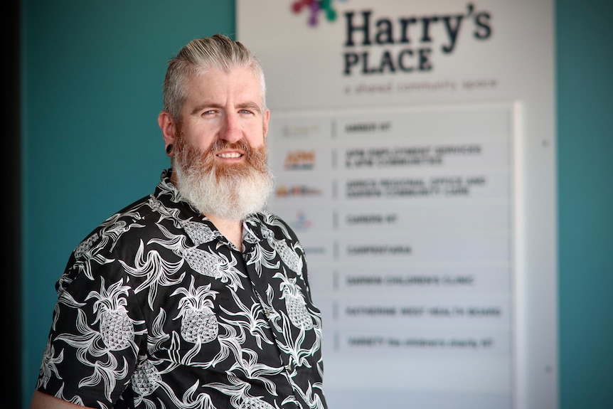 a man with a white/ginger beard wearing a printed shirt