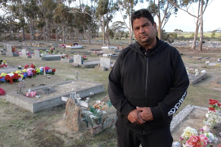 Robbie Miniter stands in Gnowangerup cemetary