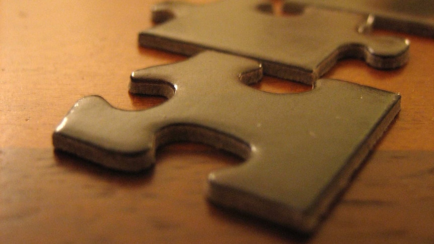 Jigsaw pieces on a wooden table