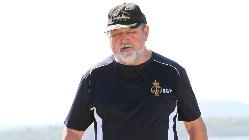 Keith Bailey wears a Navy shirt and cap.