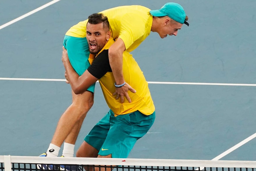 Nick Kyrgios lifts up Alex De Minaur in celebration.