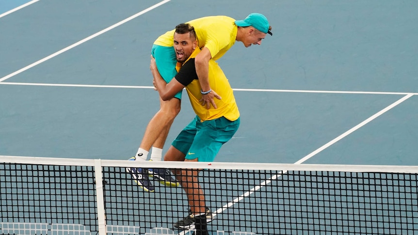 Nick Kyrgios lifts up Alex De Minaur in celebration.