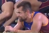 Luke Hodge lies on the ground on his belly as a reporter interviews him