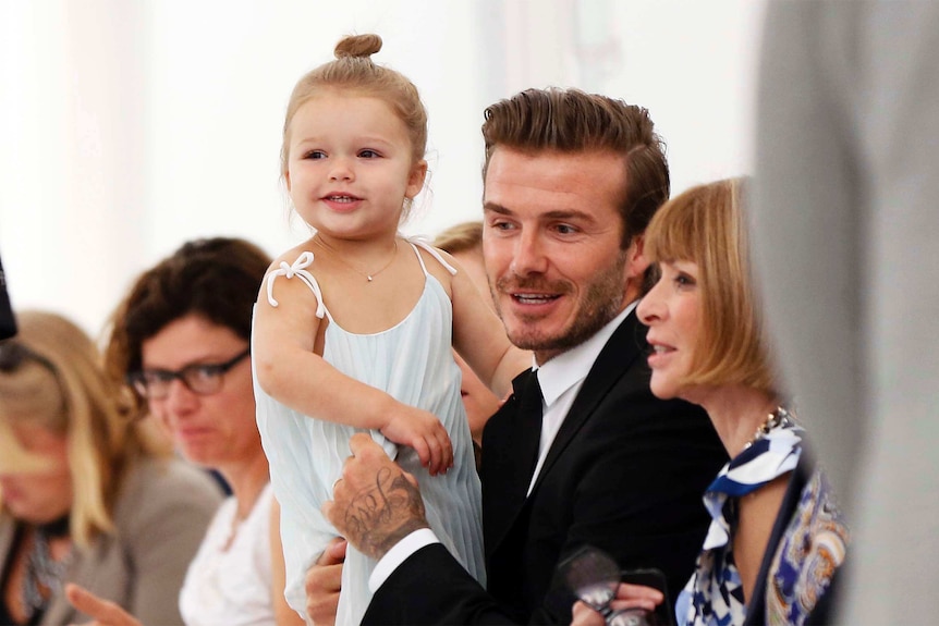 David Beckham holds his daughter Harper